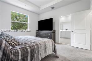2781 Northwest 55th Way Lauderhill, FL 33313 - Photo 9 of 12 a bedroom with a bed and a flat screen tv