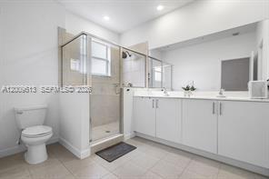 2781 Northwest 55th Way Lauderhill, FL 33313 - Photo 10 of 12 a bathroom with a double vanity sink toilet and a mirror