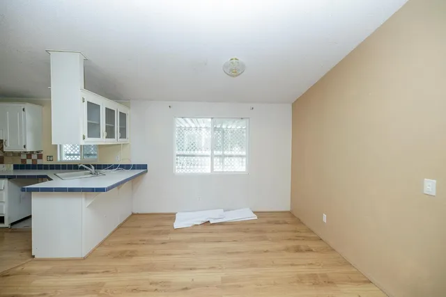 a kitchen with granite countertop a sink and cabinets