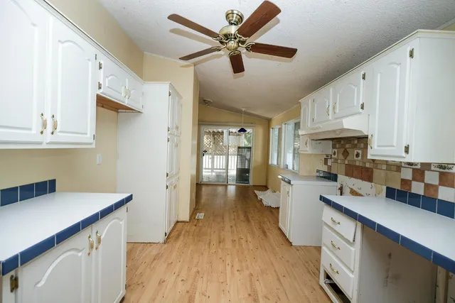 a kitchen with cabinets a sink and appliances