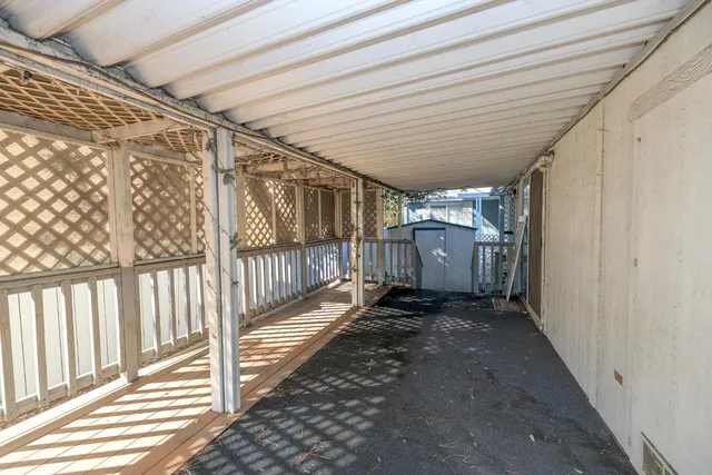 a view of a house with a wooden deck