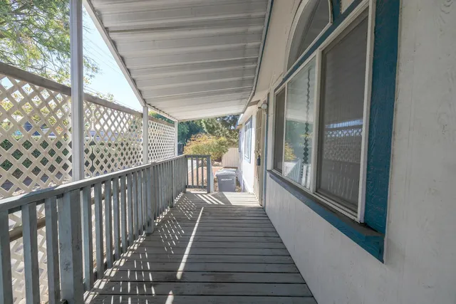 a view of balcony with wooden floor
