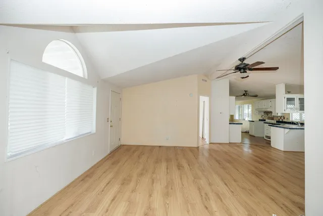 a view of a kitchen with a sink and wooden floor