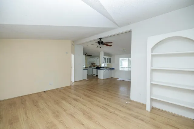 a view of kitchen and hall with wooden floor