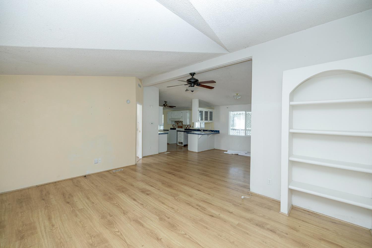 2621 Prescott Road, Unit 160 Modesto, CA 95350 - Photo 9 of 37 a view of kitchen and hall with wooden floor