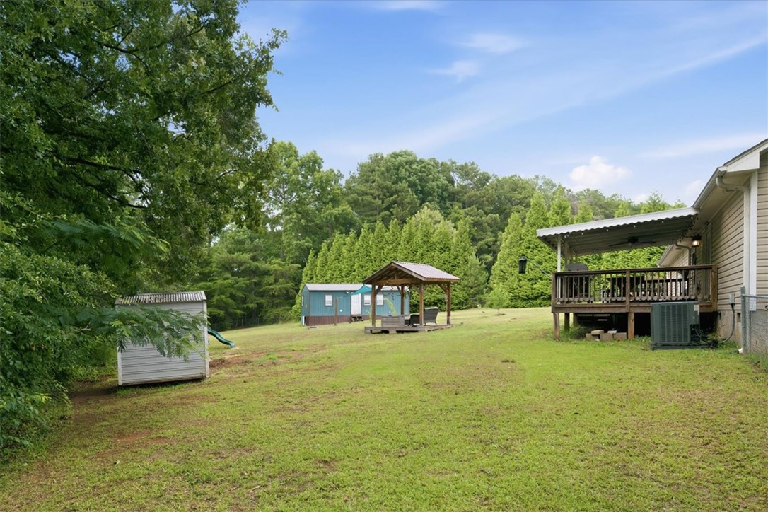 520 Sharon Lane Seneca, SC 29678 - Photo 36 of 48 A spacious, verdant yard with mature trees offers a private outdoor retreat and covered deck.