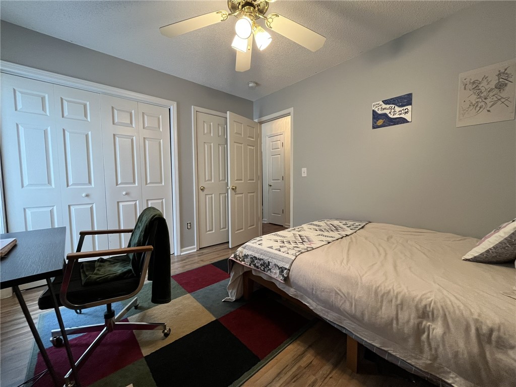 116 Arbors Court Central, SC 29630 - Photo 23 of 27 A well-appointed bedroom featuring ample closet space and warm wood-style flooring.