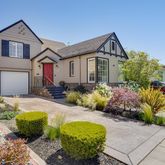 a front view of a house with a yard garage and outdoor seating