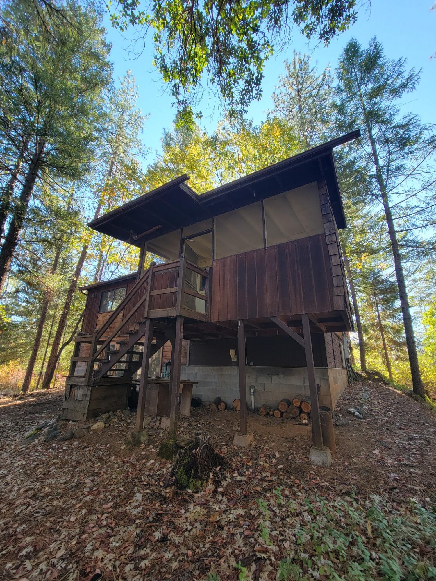 330 Lake Road Junction City, CA 96048 - Photo 6 of 50 a view of a wooden house with a yard and large tree