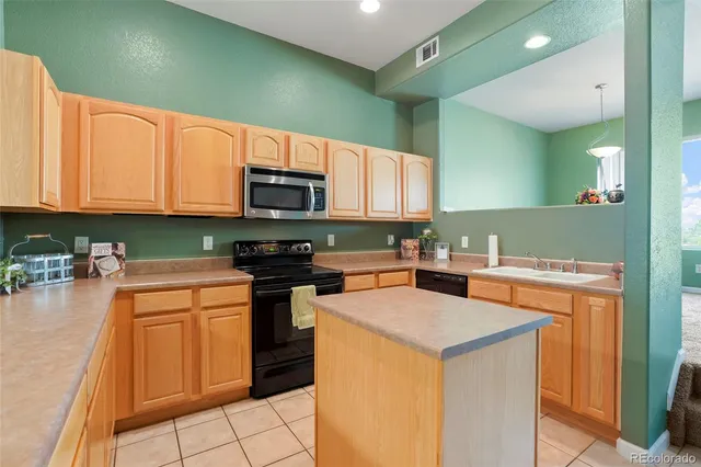 a kitchen with a stove a sink and a microwave