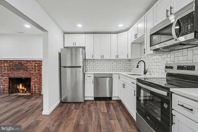 a kitchen with a refrigerator stove and sink