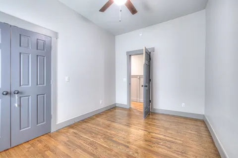 a view of an empty room with wooden floor