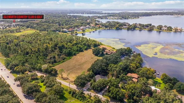 an aerial view of a house with a lake view