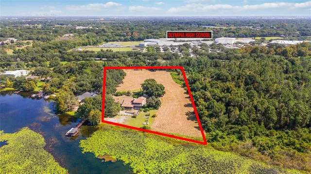 an aerial view of a houses with a swimming pool