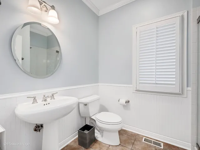 a bathroom with a sink a mirror and a toilet