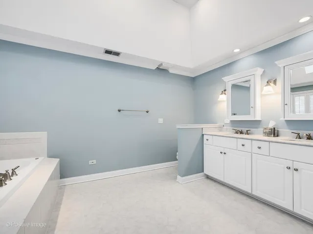 a spacious bathroom with a granite countertop sink and a mirror