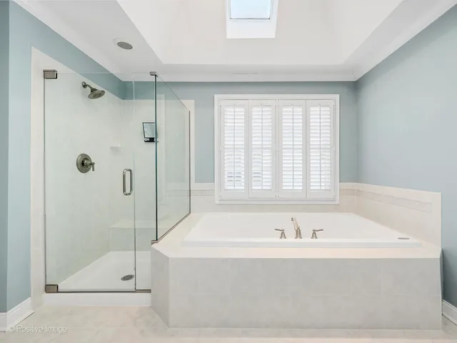a white bath tub sitting next to a shower