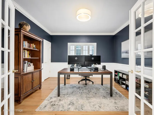 a living room with furniture a rug and a book shelf