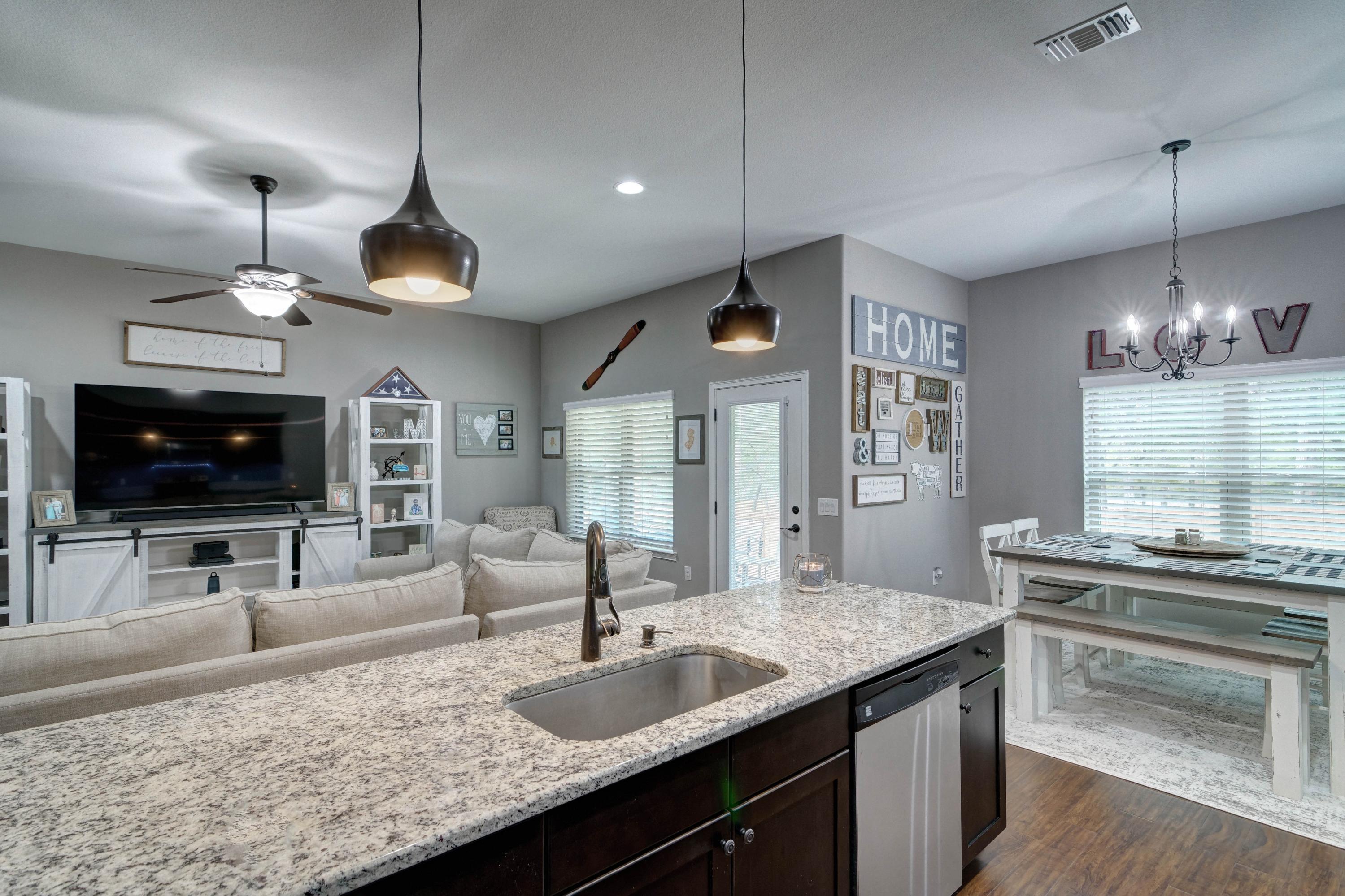 3083 5 Forks Road Navarre, FL 32566 - Photo 16 of 57 a kitchen with granite countertop a sink a counter space appliances and cabinets