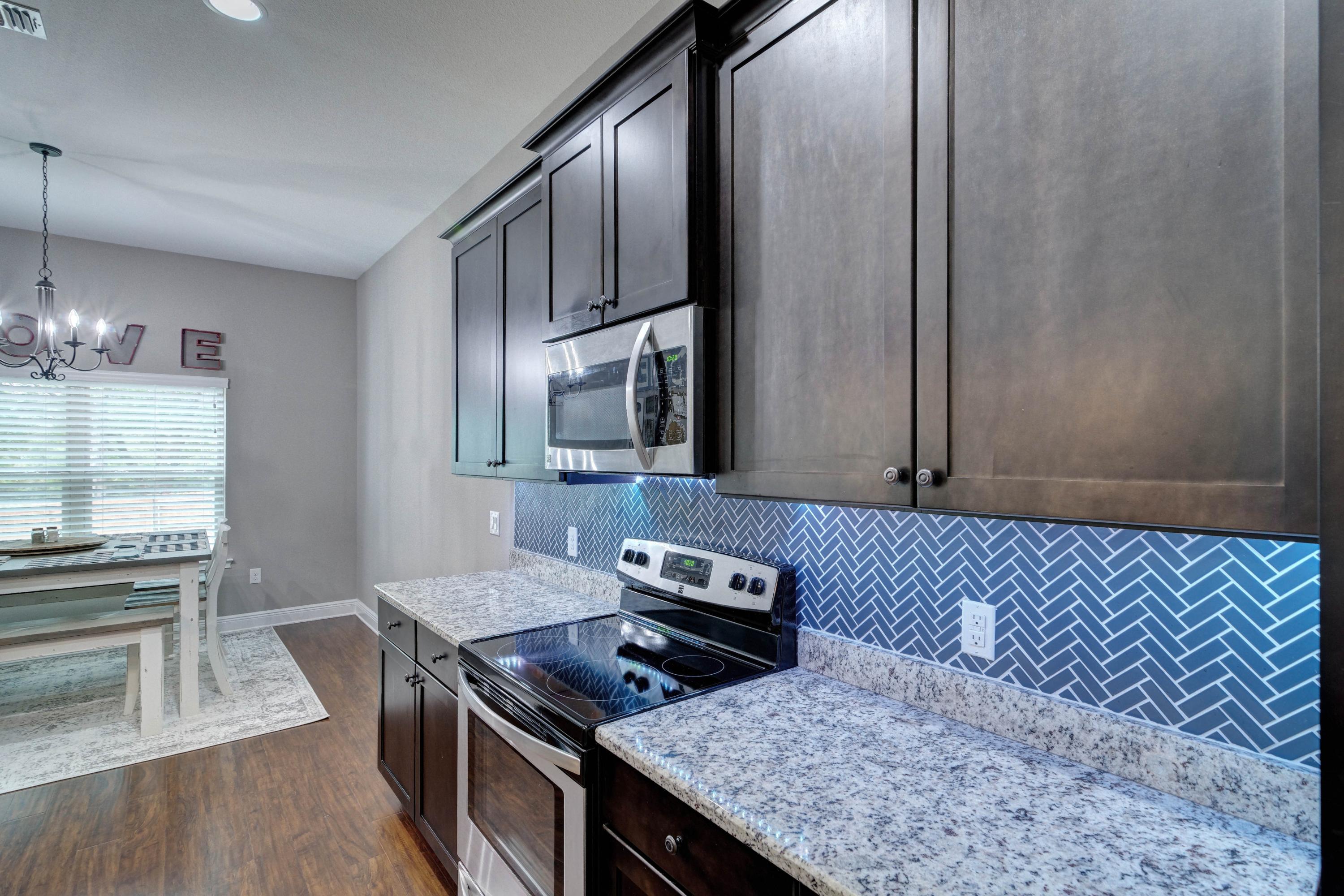 3083 5 Forks Road Navarre, FL 32566 - Photo 17 of 57 a kitchen with stainless steel appliances granite countertop a sink stove and refrigerator