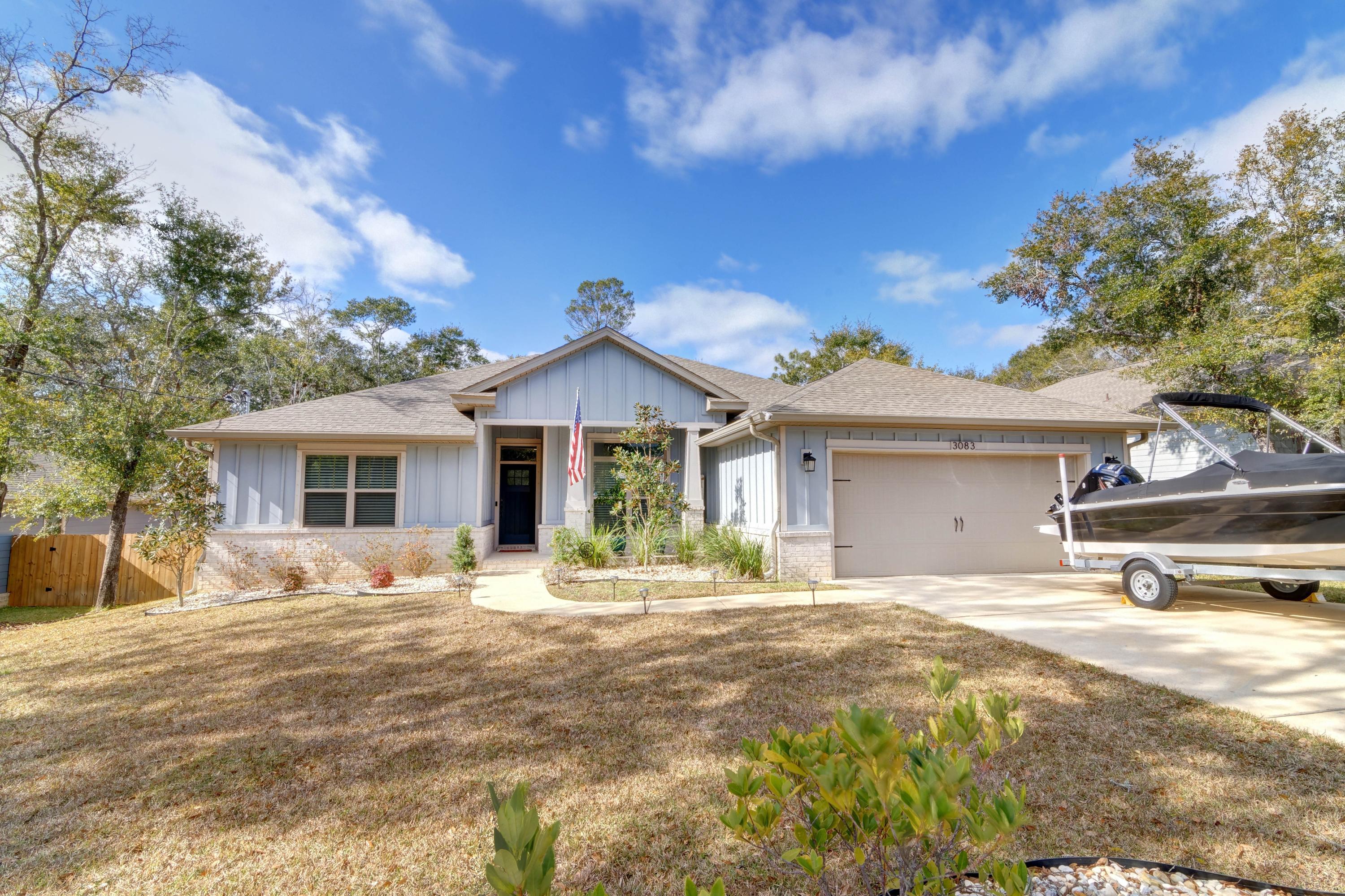 3083 5 Forks Road Navarre, FL 32566 - Photo 2 of 57 a front view of a house with a patio