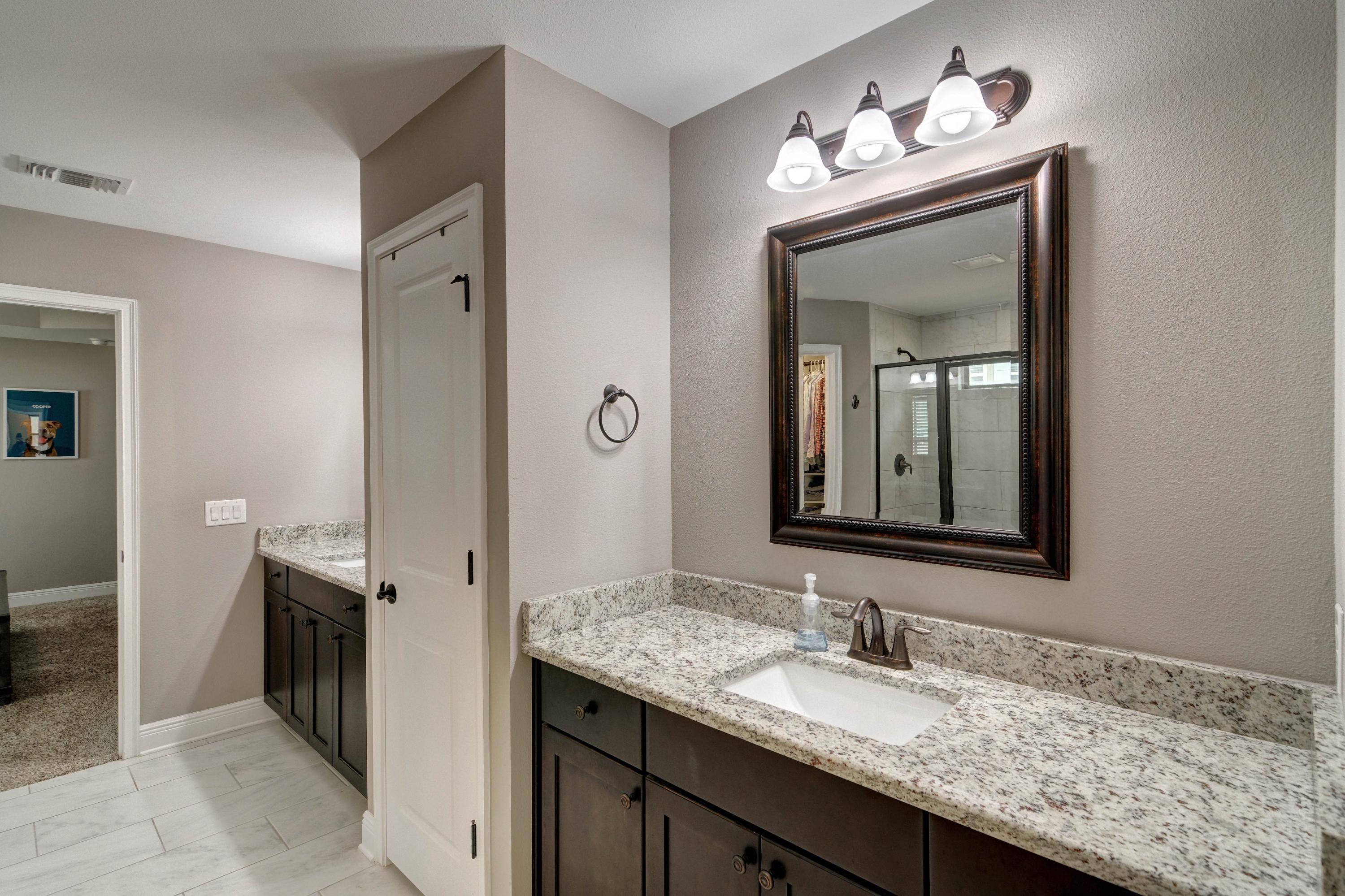 3083 5 Forks Road Navarre, FL 32566 - Photo 28 of 57 a en suite bathroom with a granite countertop sink and a mirror