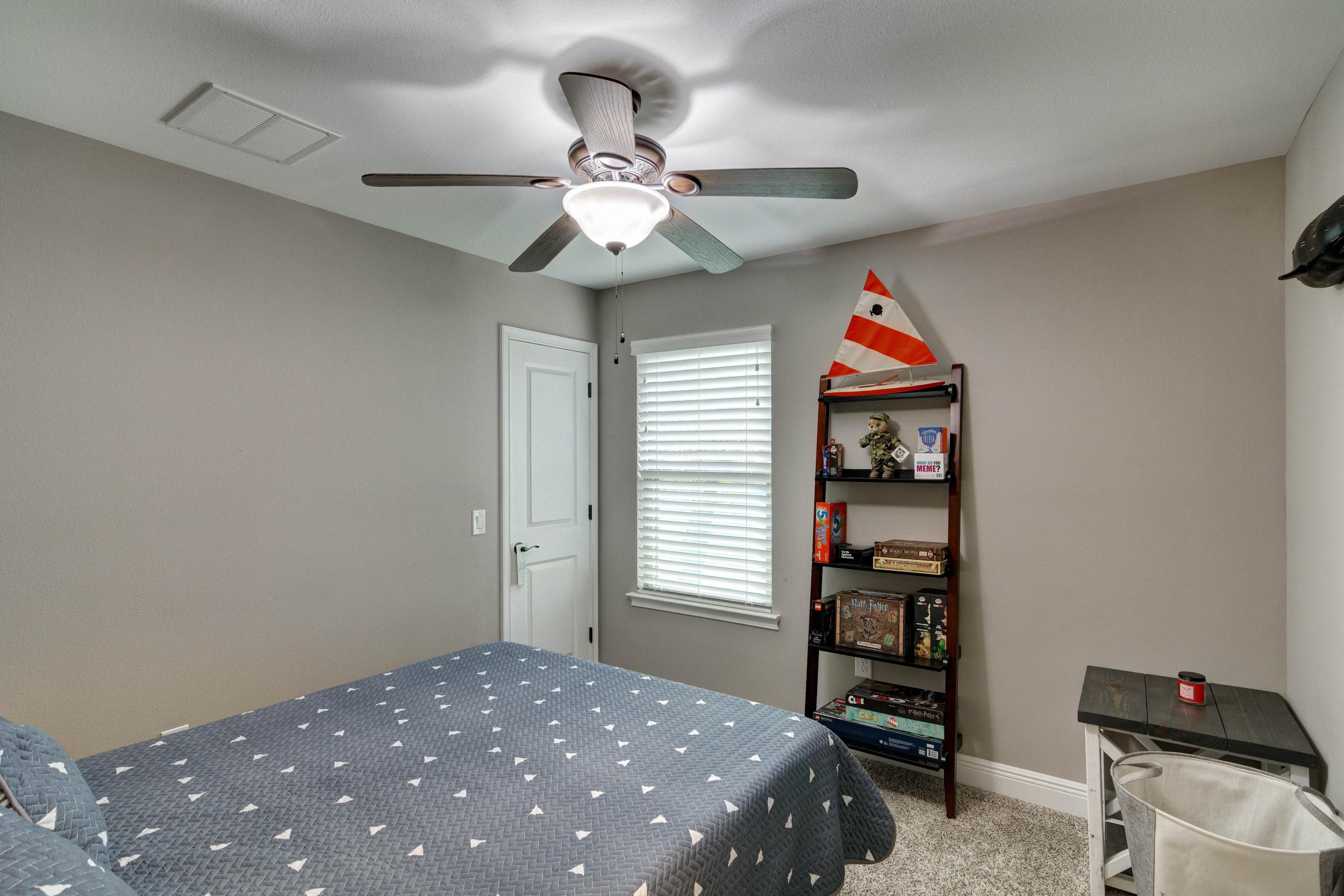 3083 5 Forks Road Navarre, FL 32566 - Photo 35 of 57 a bedroom with a bed and a chandelier