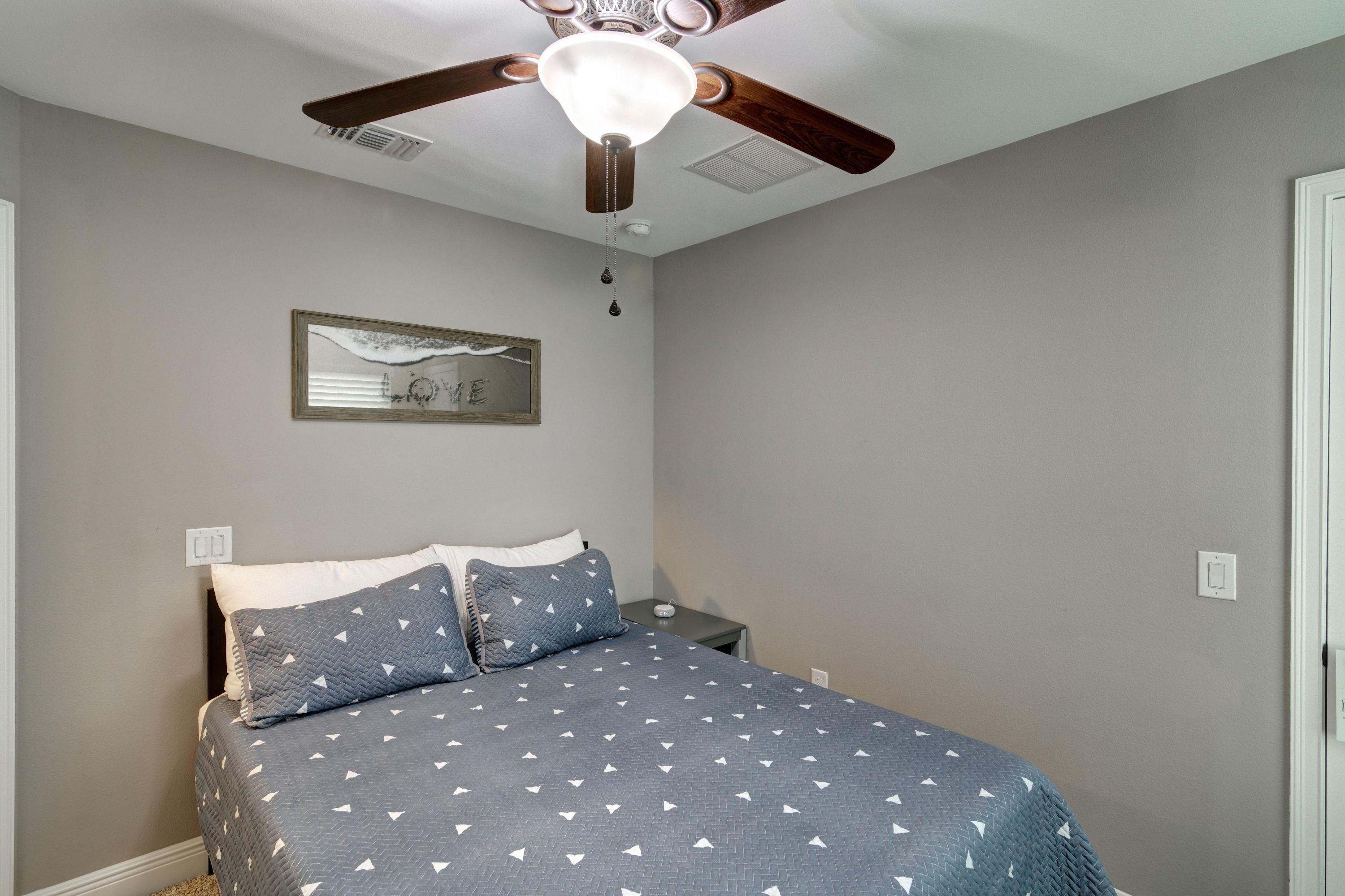 3083 5 Forks Road Navarre, FL 32566 - Photo 36 of 57 a large bedroom with a bed and a chandelier