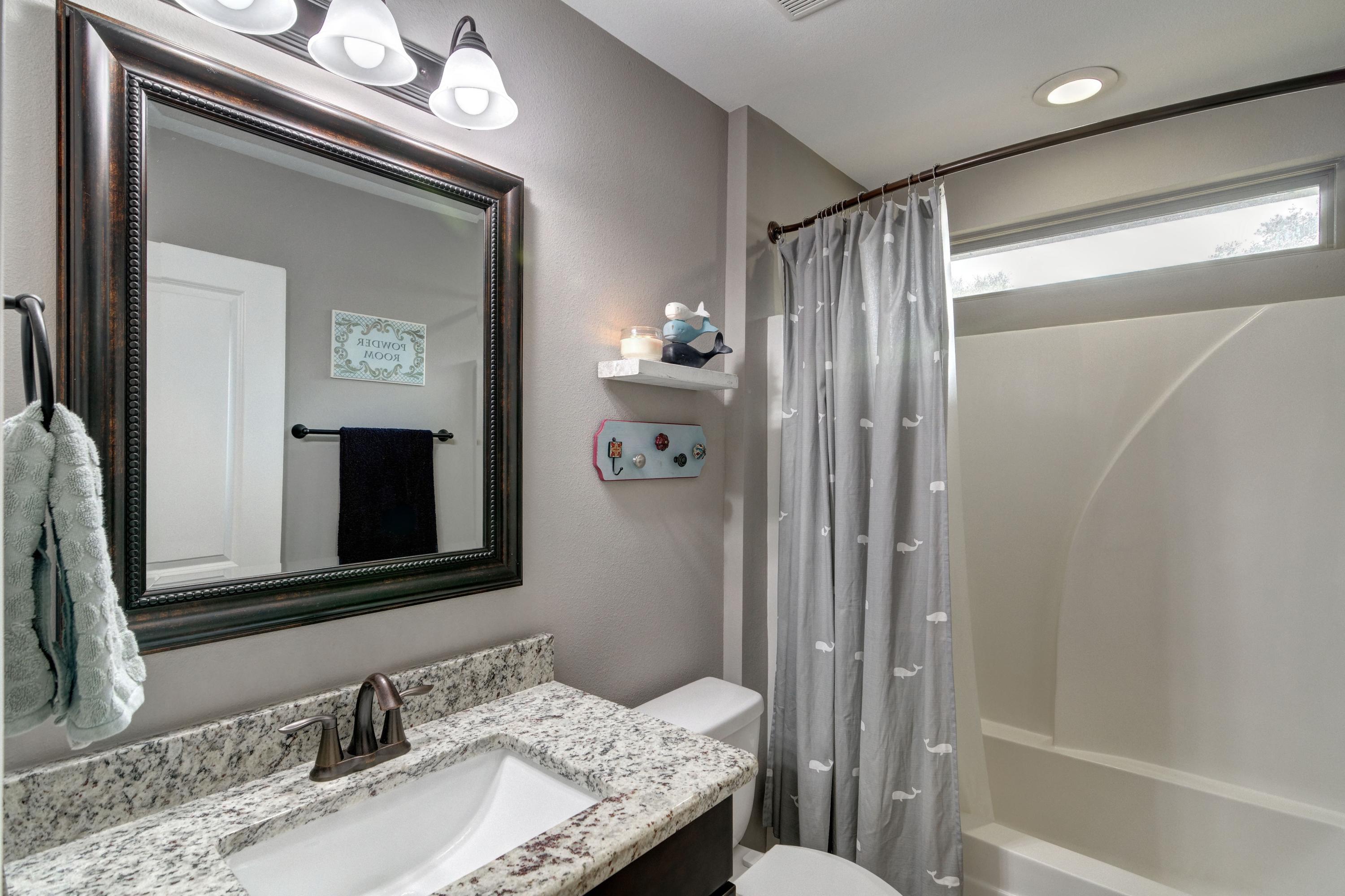 3083 5 Forks Road Navarre, FL 32566 - Photo 38 of 57 a bathroom with a granite countertop sink a mirror and a bathtub