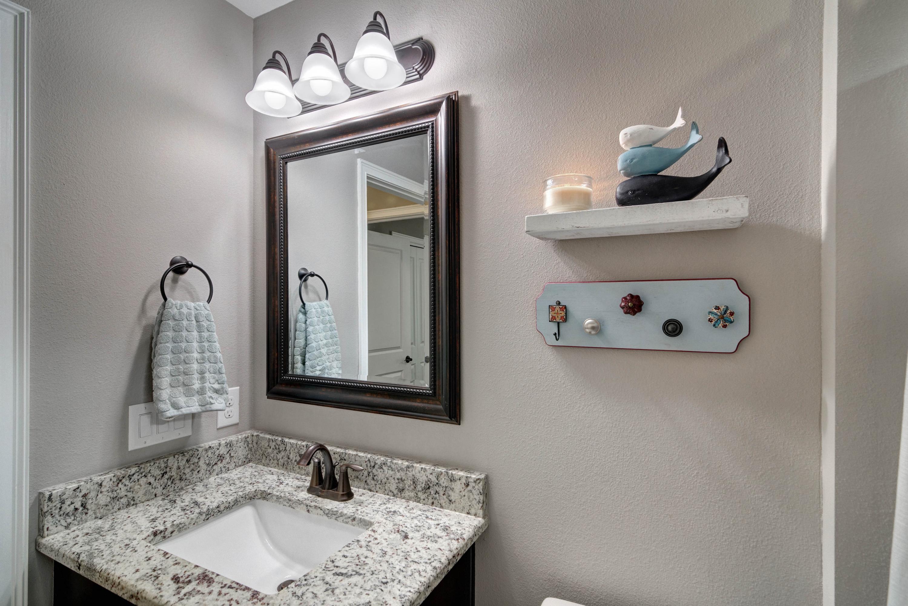 3083 5 Forks Road Navarre, FL 32566 - Photo 39 of 57 a bathroom with a sink vanity and mirror
