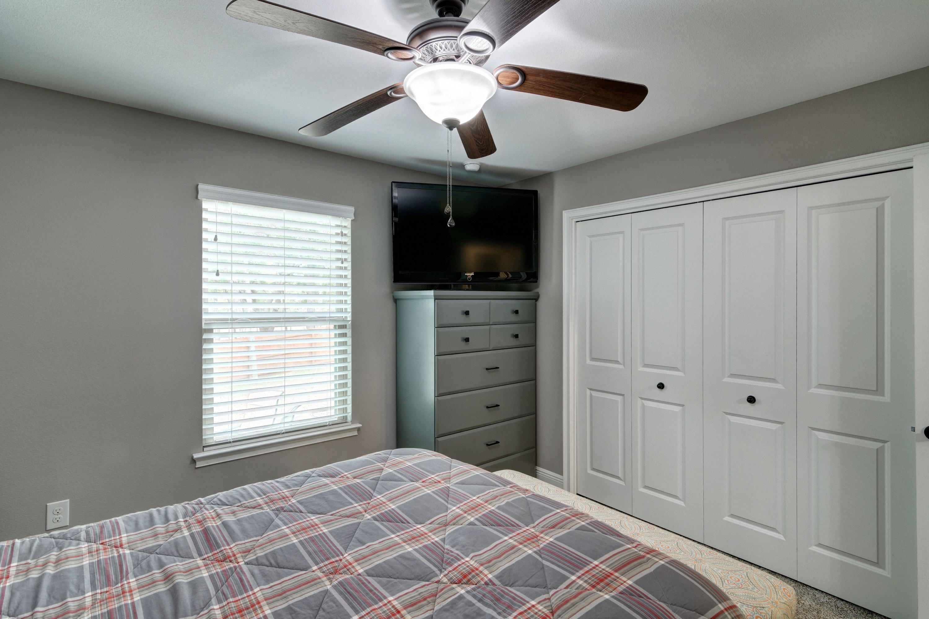 3083 5 Forks Road Navarre, FL 32566 - Photo 41 of 57 a bedroom with windows and a chandelier fan