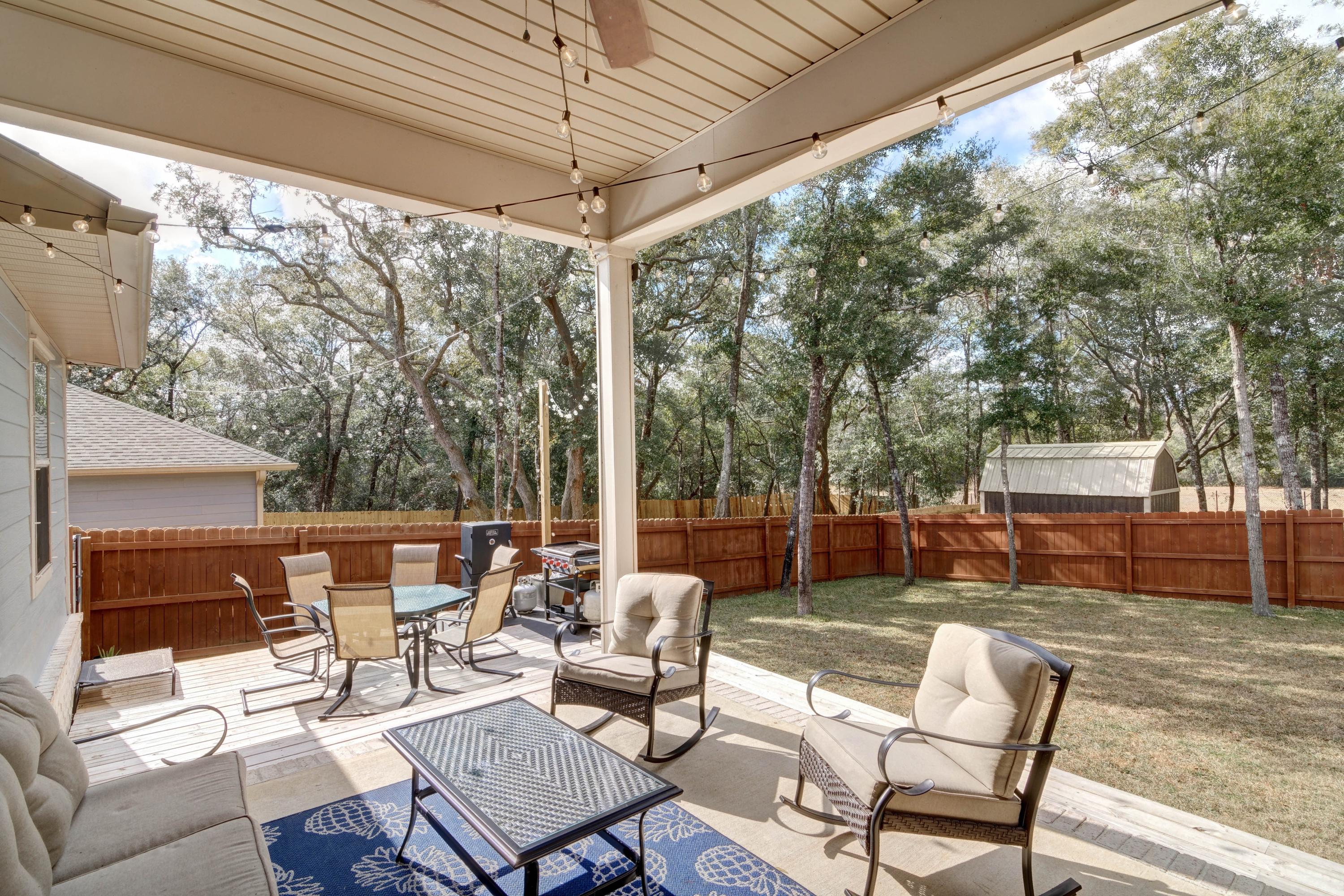 3083 5 Forks Road Navarre, FL 32566 - Photo 44 of 57 a patio with yard glass top table and chairs