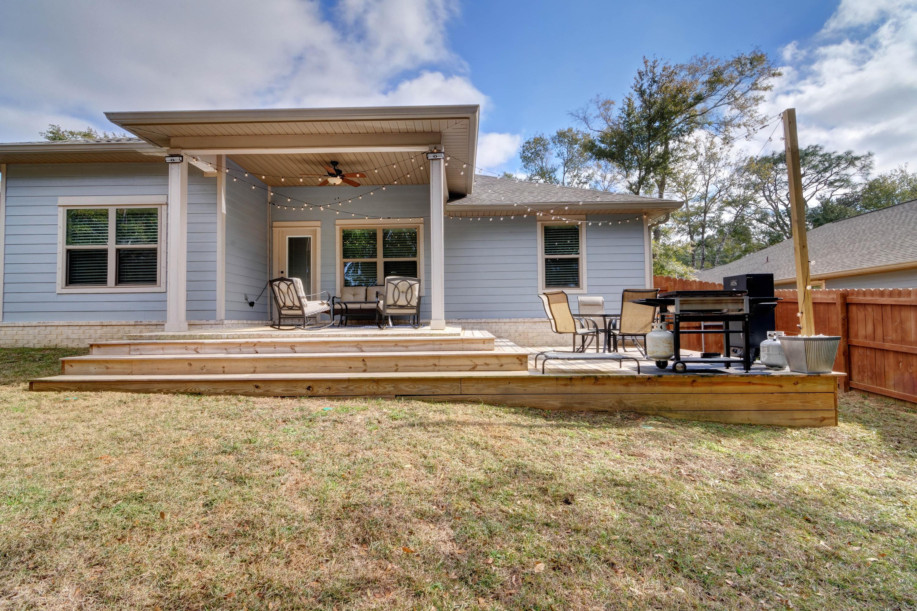 3083 5 Forks Road Navarre, FL 32566 - Photo 45 of 57 a view of a house with swimming pool and a porch with furniture