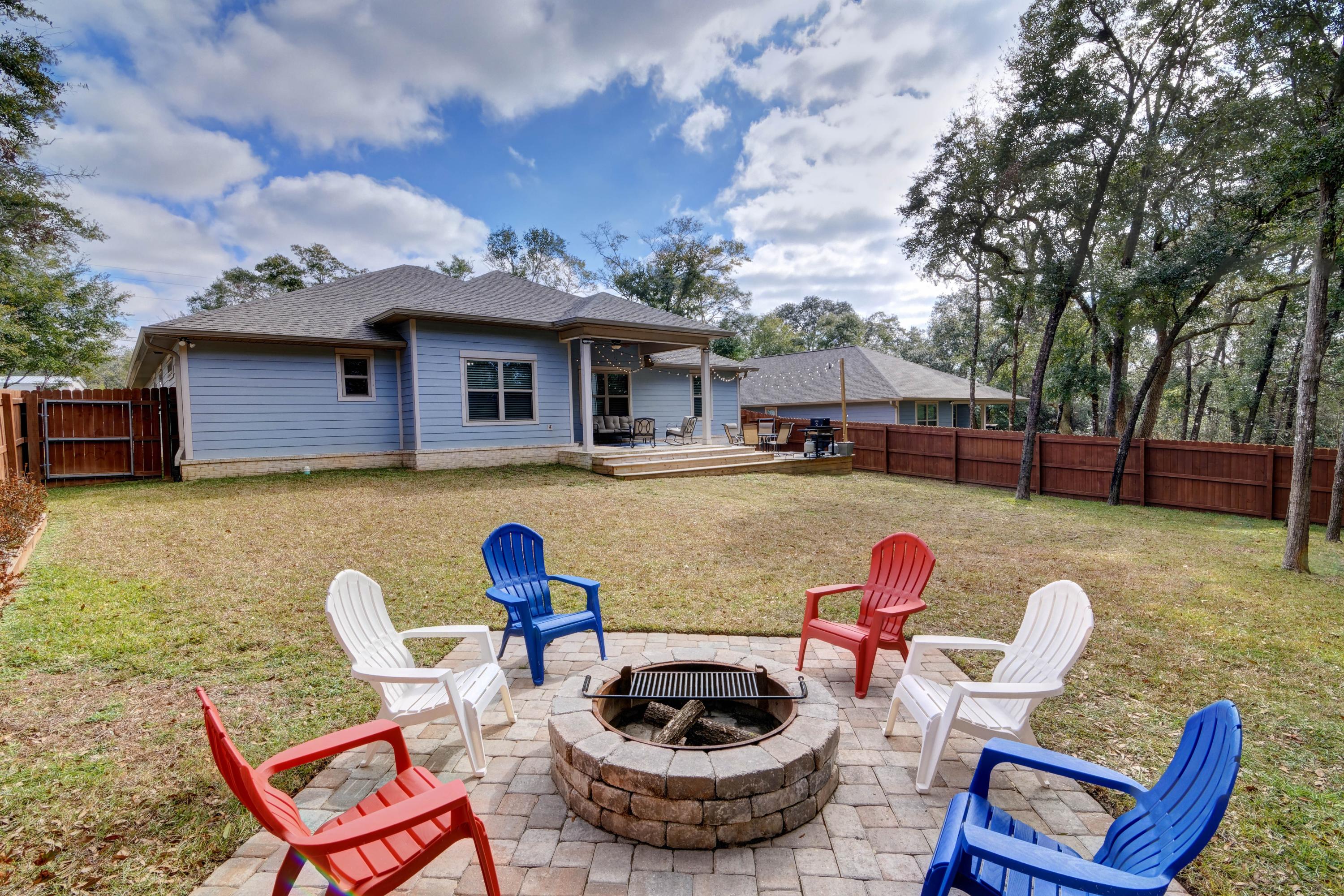 3083 5 Forks Road Navarre, FL 32566 - Photo 51 of 57 a view of a house with backyard furniture and a fire pit