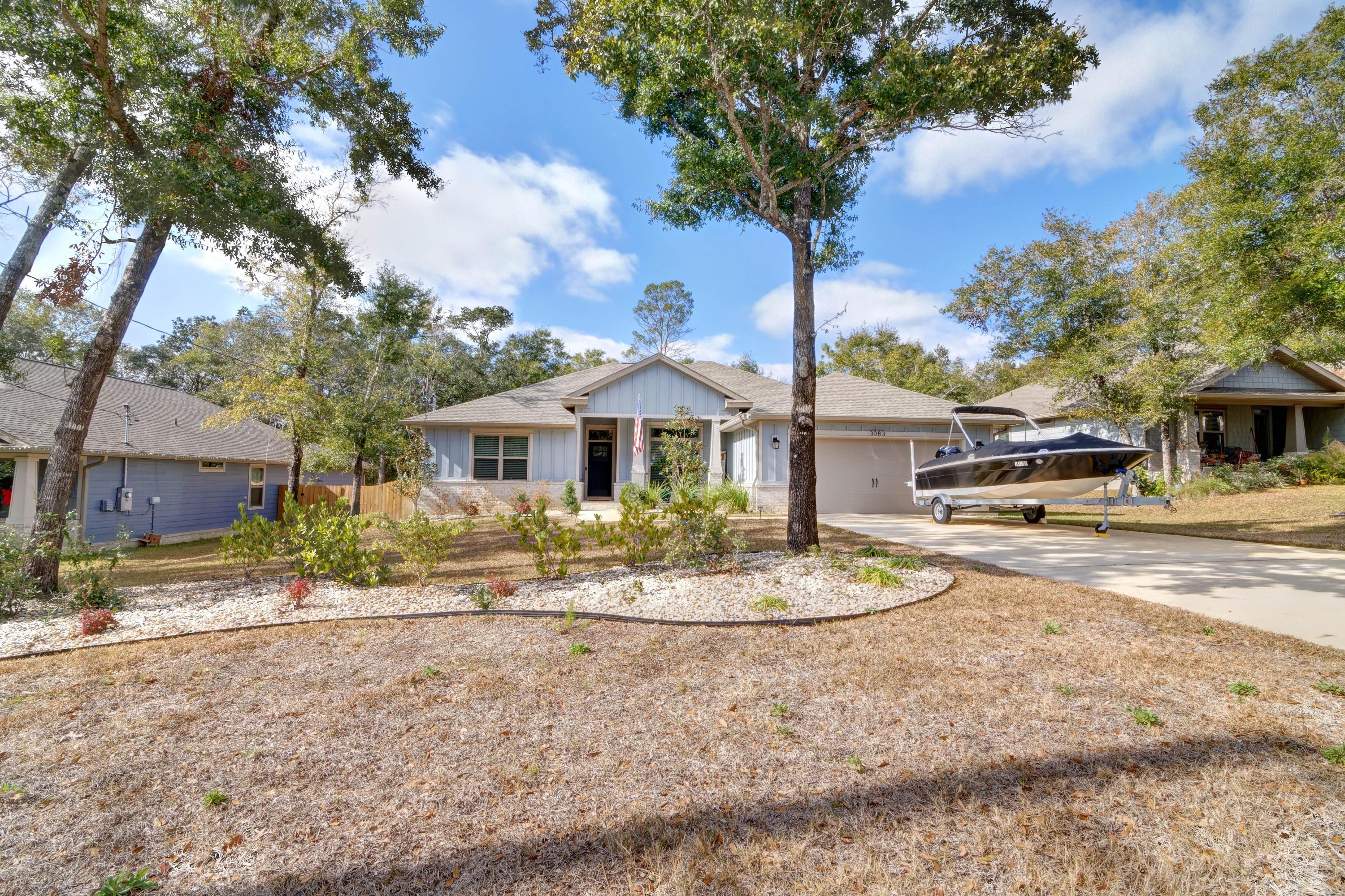 3083 5 Forks Road Navarre, FL 32566 - Photo 57 of 57 a front view of a house with a yard and garage