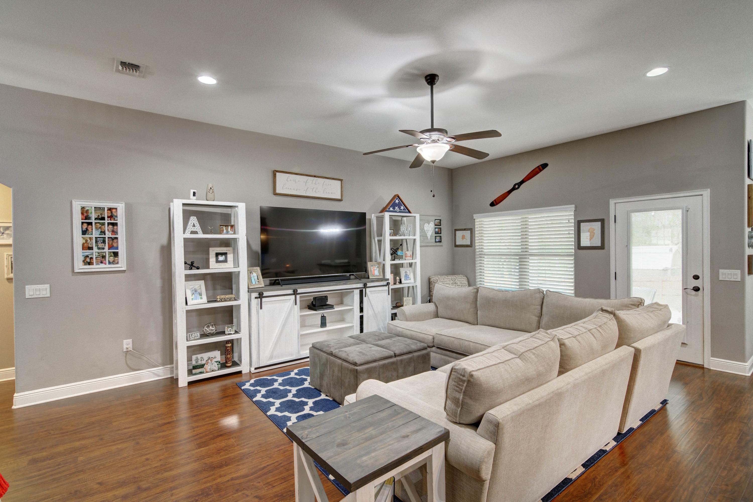 3083 5 Forks Road Navarre, FL 32566 - Photo 9 of 57 a living room with furniture and a flat screen tv