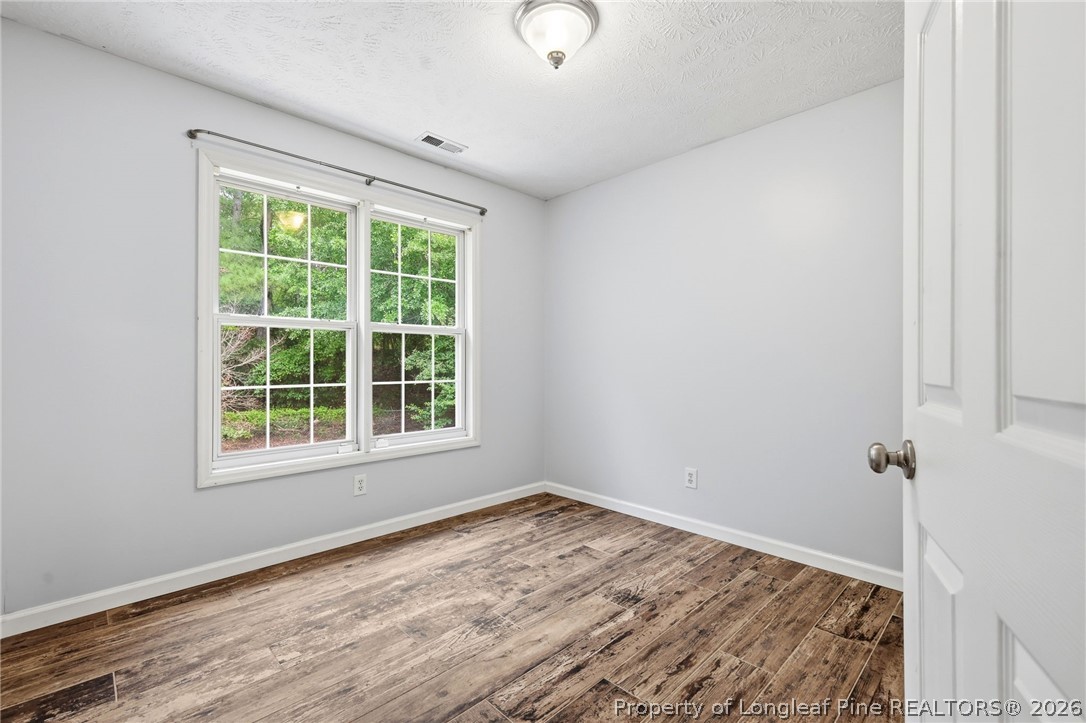 5113 Archer Road Hope Mills, NC 28348 - Photo 23 of 41 a view of a room with wooden floor and windows
