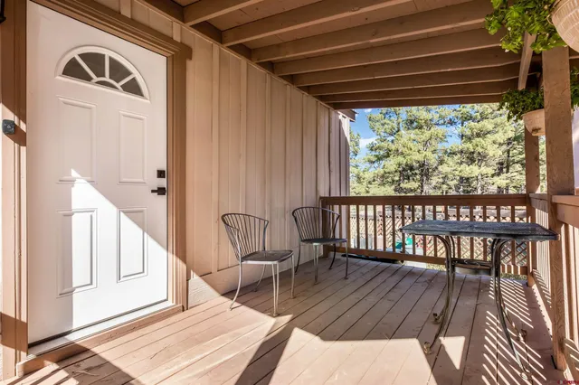 a view of a chairs and table in balcony