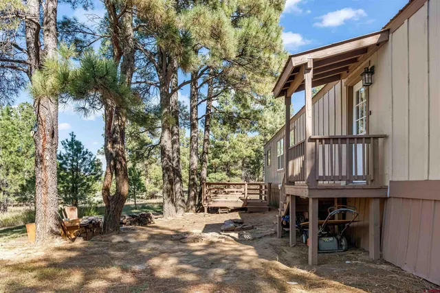 a backyard of a house with barbeque oven and outdoor seating
