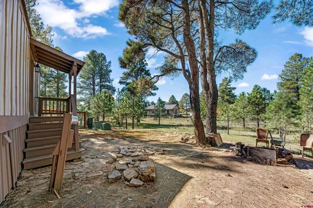a view of a backyard with sitting area