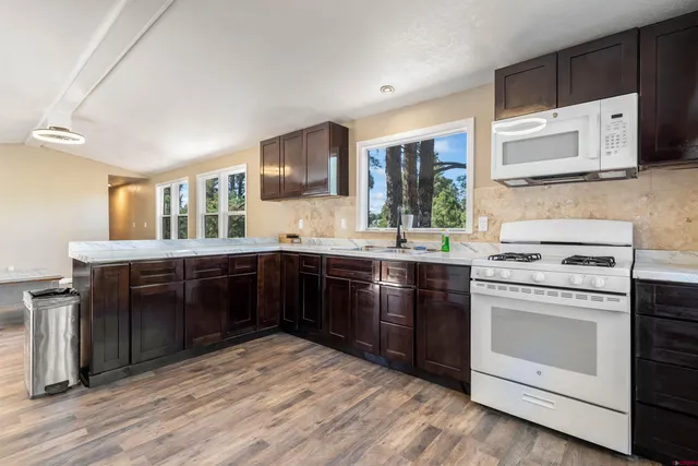 a kitchen with stainless steel appliances granite countertop a stove and a sink