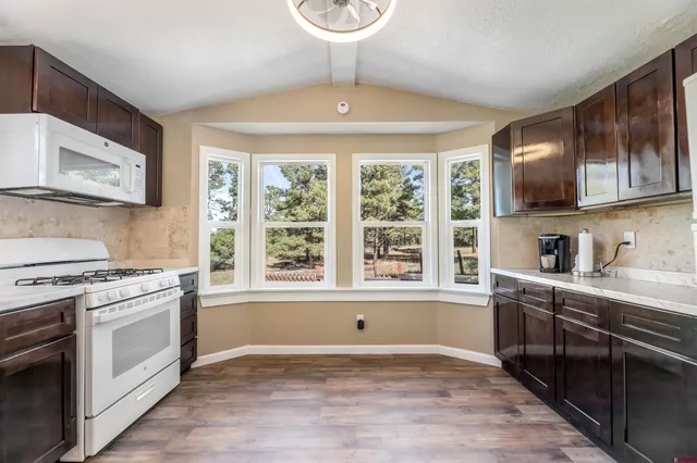a kitchen with a stove a sink and a microwave