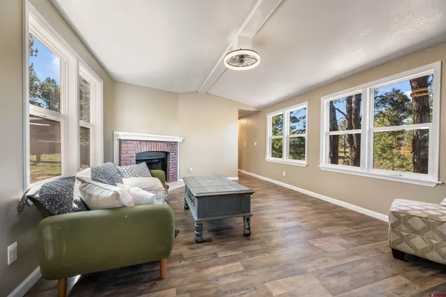 a living room with furniture and a fireplace