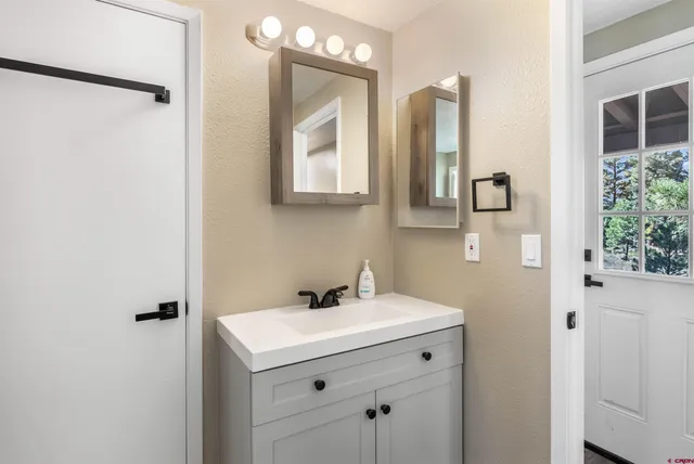 a bathroom with a sink and mirror