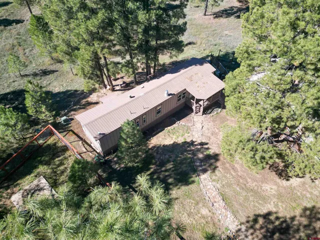 an aerial view of a house with a yard