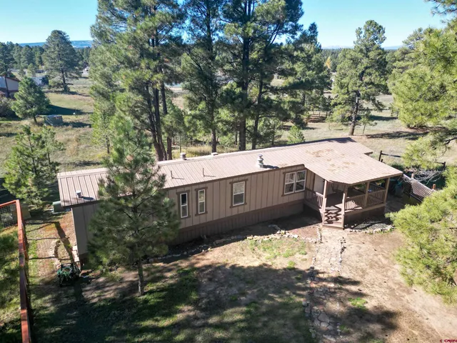 a view of a house with a yard and sitting area