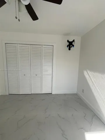 an empty room with a ceiling fan