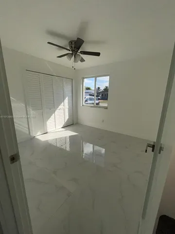 a view of a livingroom with a refrigerator