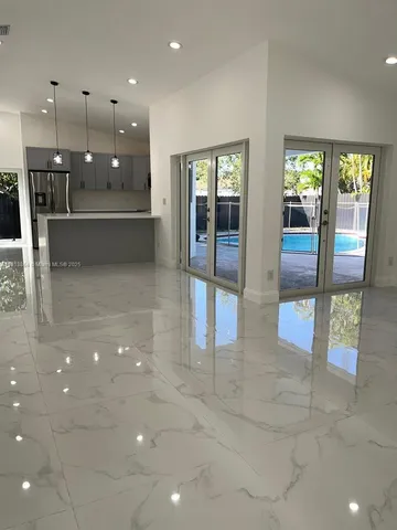 a view of an entryway with a dining space and windows