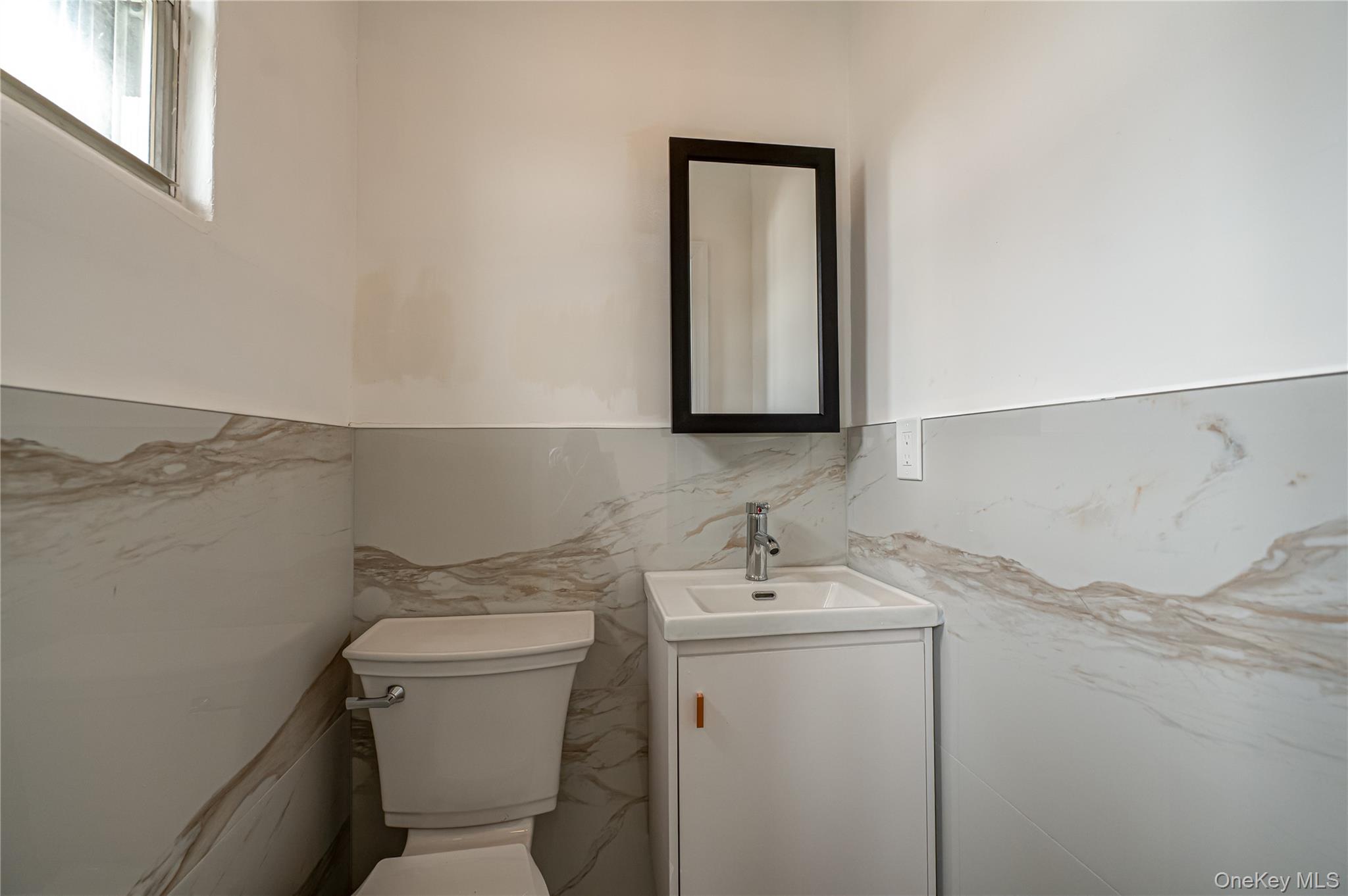10 Gerhard Road Plainview, NY 11803 - Photo 11 of 13 a bathroom with a toilet sink and mirror